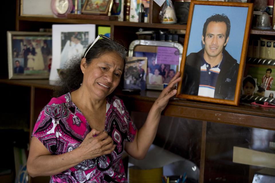 In this Feb. 5, 2014, photo, Maria Gonzalez, touches a picture of her son Cesar, during an interview with The Associated Press inside her home in Yautepec, Mexico. In 2012. Cesar, a 33-year-old architect and engineer, was kidnapped as he drove through Cuernavaca to visit his family in Yautepec. The family got together $10,000 and left it in packets of $2,000 in a cereal box in Cuernavaca. Five days later he was found dead in the trunk of his car. (AP Photo/Eduardo Verdugo)