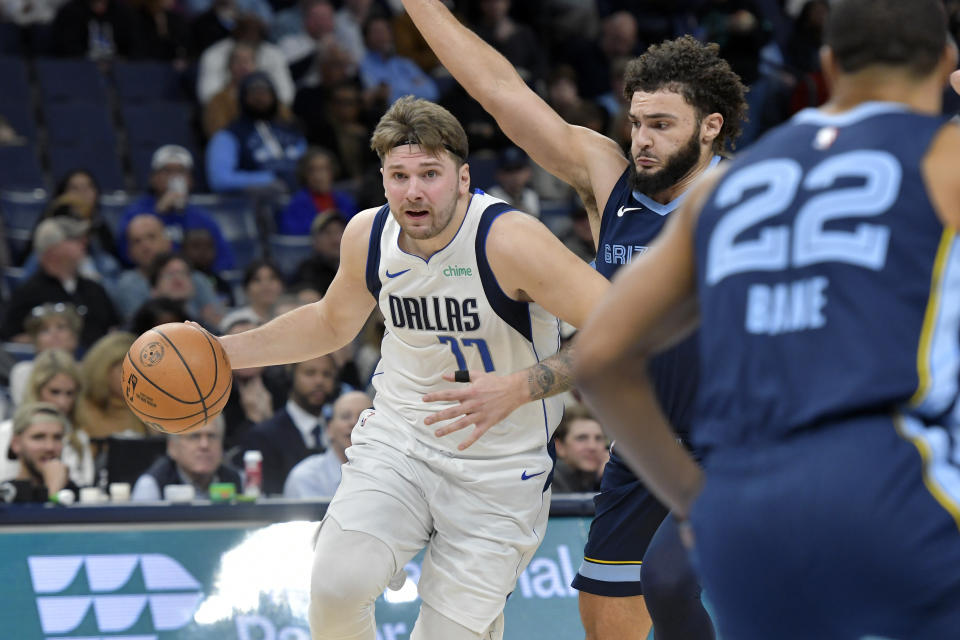 Dallas Mavericks guard Luka Doncic drives ahead of Memphis Grizzlies forward David Roddy in the first half of an NBA basketball game, Monday, Dec. 11, 2023, in Memphis, Tenn. (AP Photo/Brandon Dill)