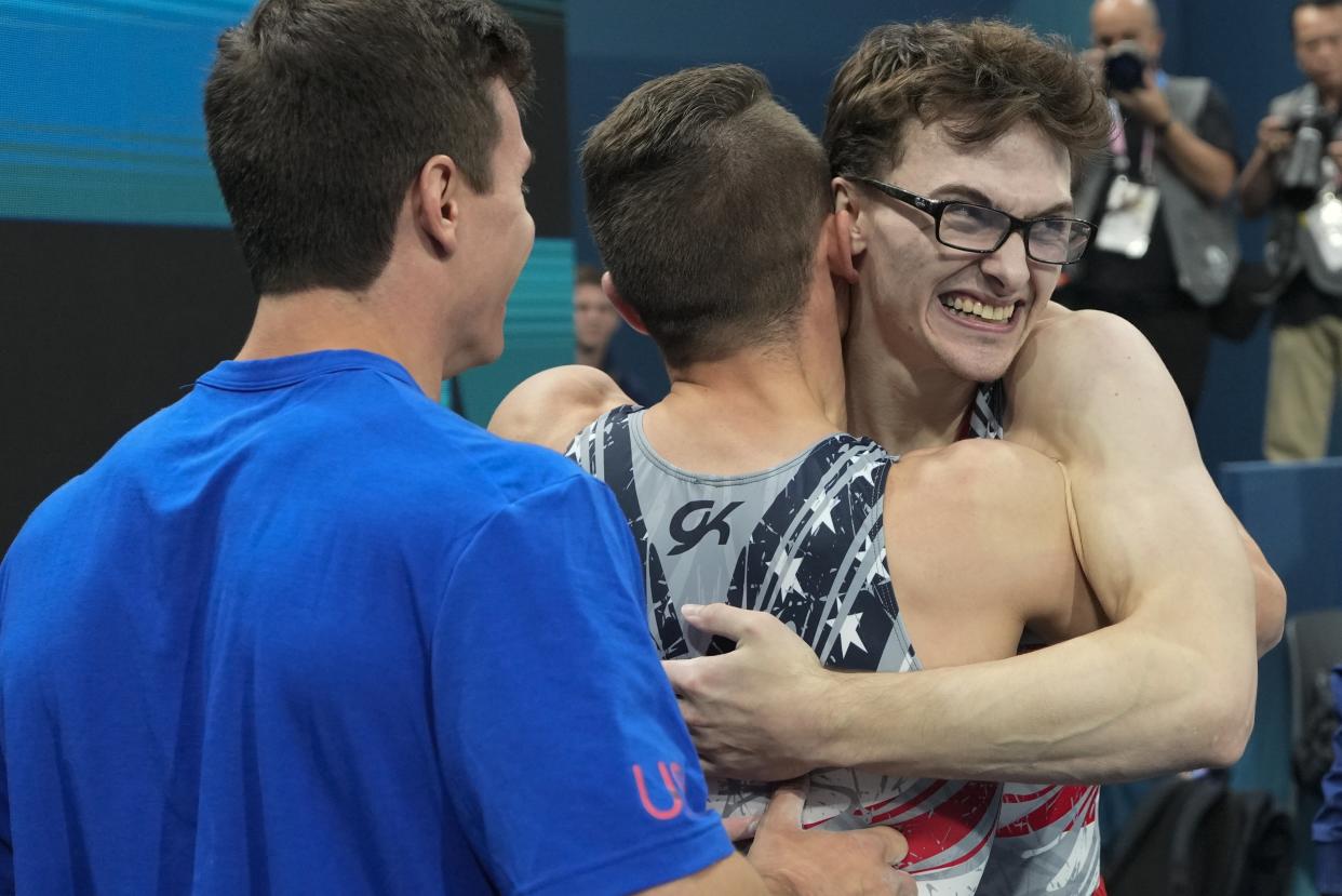 Stephen Nedoroscik gets a hug from Paul Juda during the men's artistic gymnastics team final.