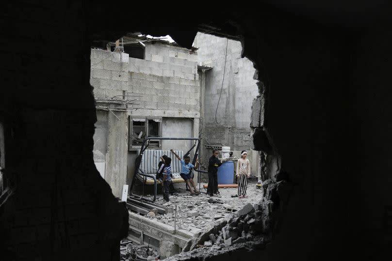 Palestinians inspect the house of Hassan Qatnani, which was destroyed by Israeli forces overnight.