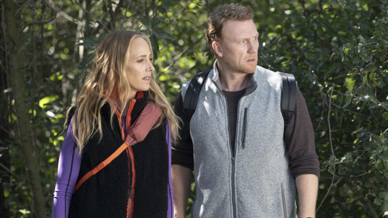  Teddy Altman (Kim Raver) and Owen Hunt (Kevin McKidd) look toward some injured people while taking a hike on the Season 20 episode of Grey's Anatomy, "Blood, Sweat and Tears.". 