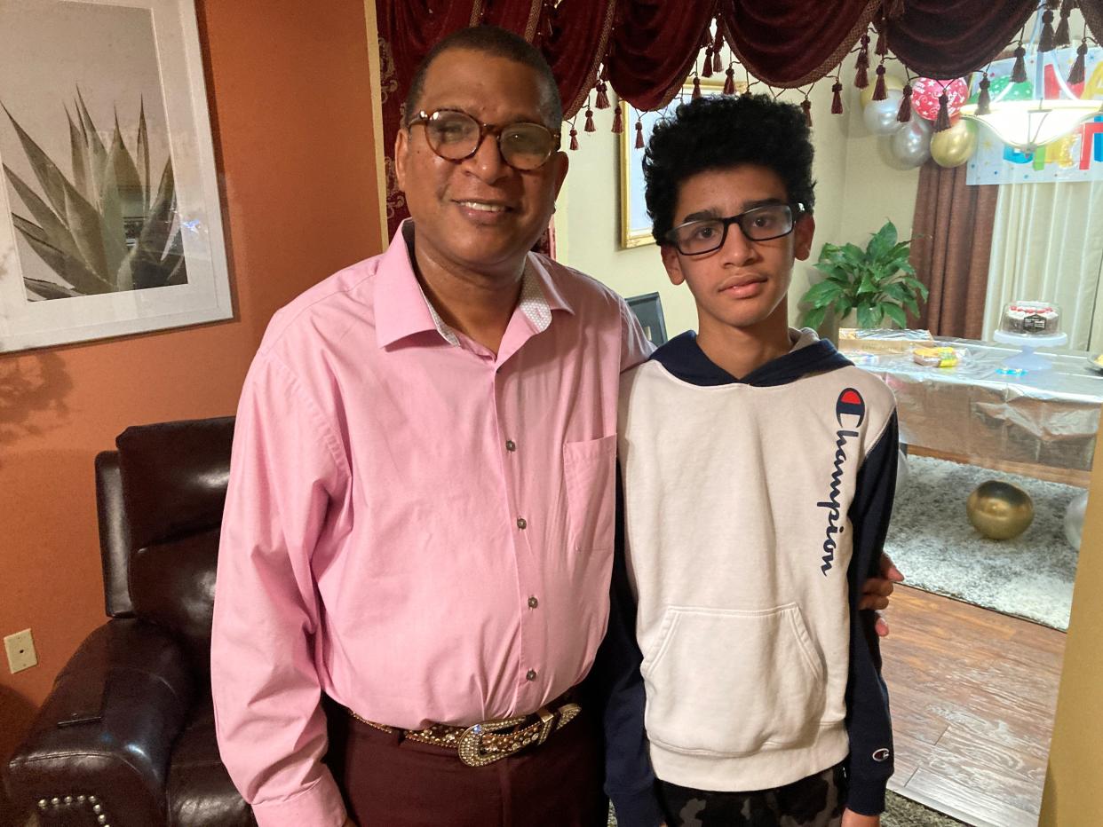 The Rev. Ruben Calzado, director of Latino Ministries for the First Baptist Church of Hamilton, with his son Samuel. Calzado says he and his wife decided to immigrate from Cuba after Samuel was born.