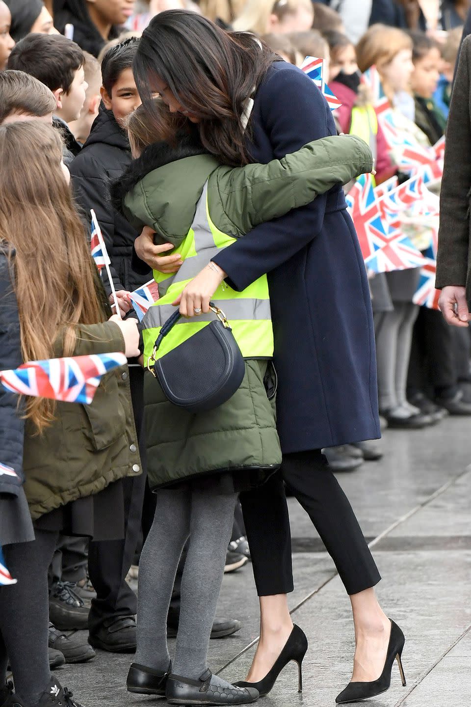 <p>Meghan embraced a young schoolgirl during a visit to Birmingham in 2018.</p>