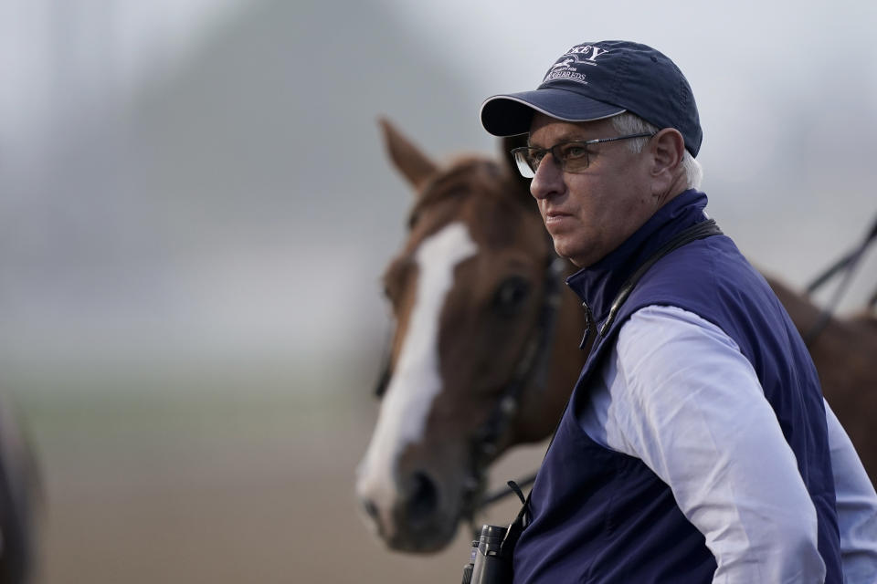 Trainer Todd Pletcher watches horses workout on the track at Churchill Downs Friday, May 6, 2022, in Louisville, Ky. The 148th running of the Kentucky Derby is scheduled for Saturday, May 7. (AP Photo/Charlie Riedel)