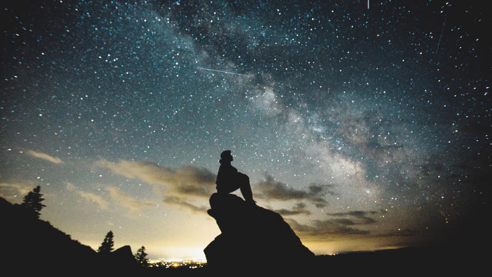 Man stargazing on a rock