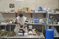 Biologist Diane Duffus tests hemp for humidity in a lab at Hepworth Farms in Milton, N.Y., Monday, April 12, 2021. Farmers dealing with depressed prices for plants that produce CBD extract are eager to take part in a statewide marijuana market expected to generate billions of dollars a year once retail sales start. They already know how to grow and process cannabis plants, since hemp is essentially the same plant with lower levels of THC, marijuana's active ingredient. Now they're waiting on rules that will allow them to switch seeds. (AP Photo/Seth Wenig)