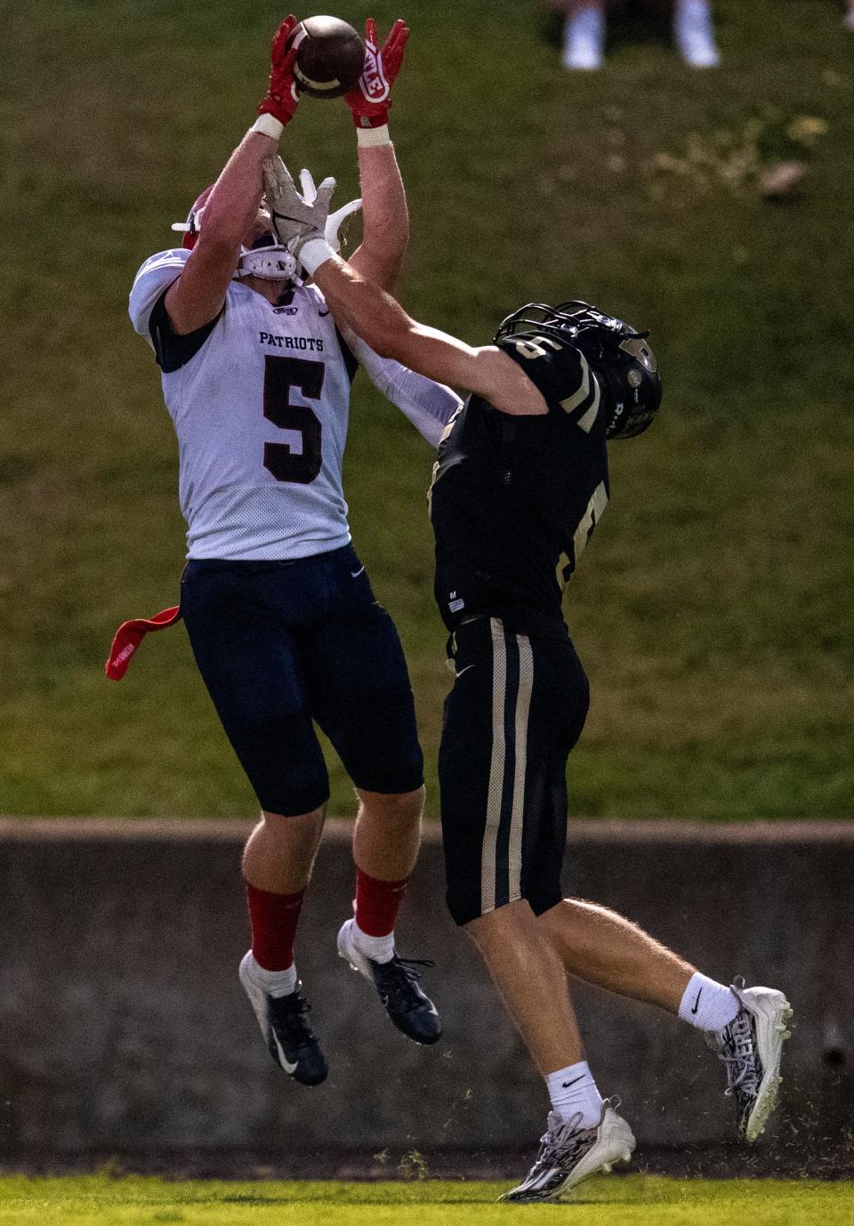 Heritage Hills' Preston Coop (5) intercepts the pass intended for Boonville's Tyler Rinehart (5) as the Heritage Hills Patriots play the Boonville Pioneers Friday, Sept. 1, 2023.