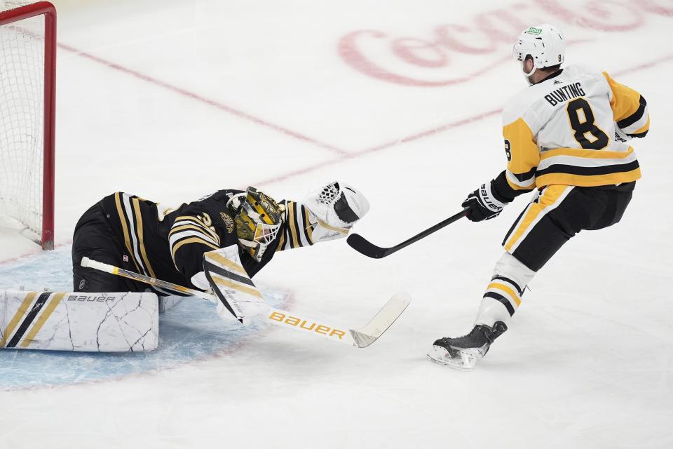 Boston Bruins' Linus Ullmark (35) makes a glove save on the shot by Pittsburgh Penguins' Michael Bunting (8) on a breakaway during the first period of an NHL hockey game, Saturday, March 9, 2024, in Boston. (AP Photo/Michael Dwyer)