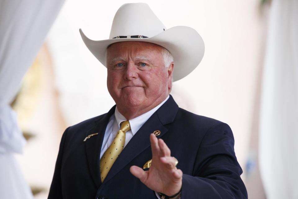 Texas Agriculture Commissioner Sid Miller waves as he arrives at Mar-a-Lago to meet with President-elect Donald Trump's transition team, Friday, Dec. 30, 2016, in Palm Beach, Fla. (AP Photo/Evan Vucci)