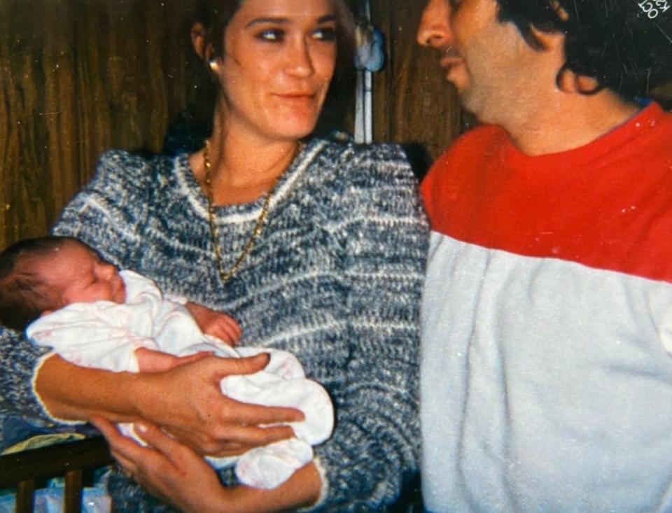 Lori Lee holds her daughter, Lauren, in the early 1990s. Lauren was only 18 months old when her mother died.