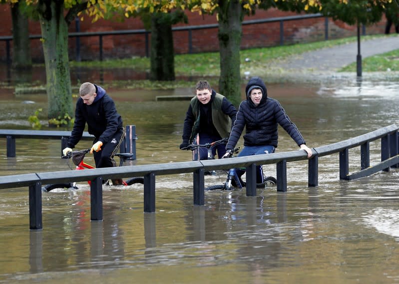 Residents cycle through floodwater in Bentley, north of Doncaster