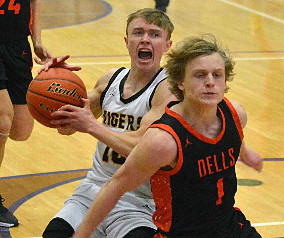 Groton Area's Lane Tietz is fouled by Dell Rapids' Cole Ruesink on a drive to the basket during their Class A SoDak 16 boys basketball game on Tuesday, March 5, 2024 in the Watertown Civic Arena. Groton Area won 69-55.