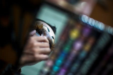 Teeraphong Meesat, 29, known as teacher Bally applies make up before his english class at the Prasartratprachakit School in Ratchaburi province