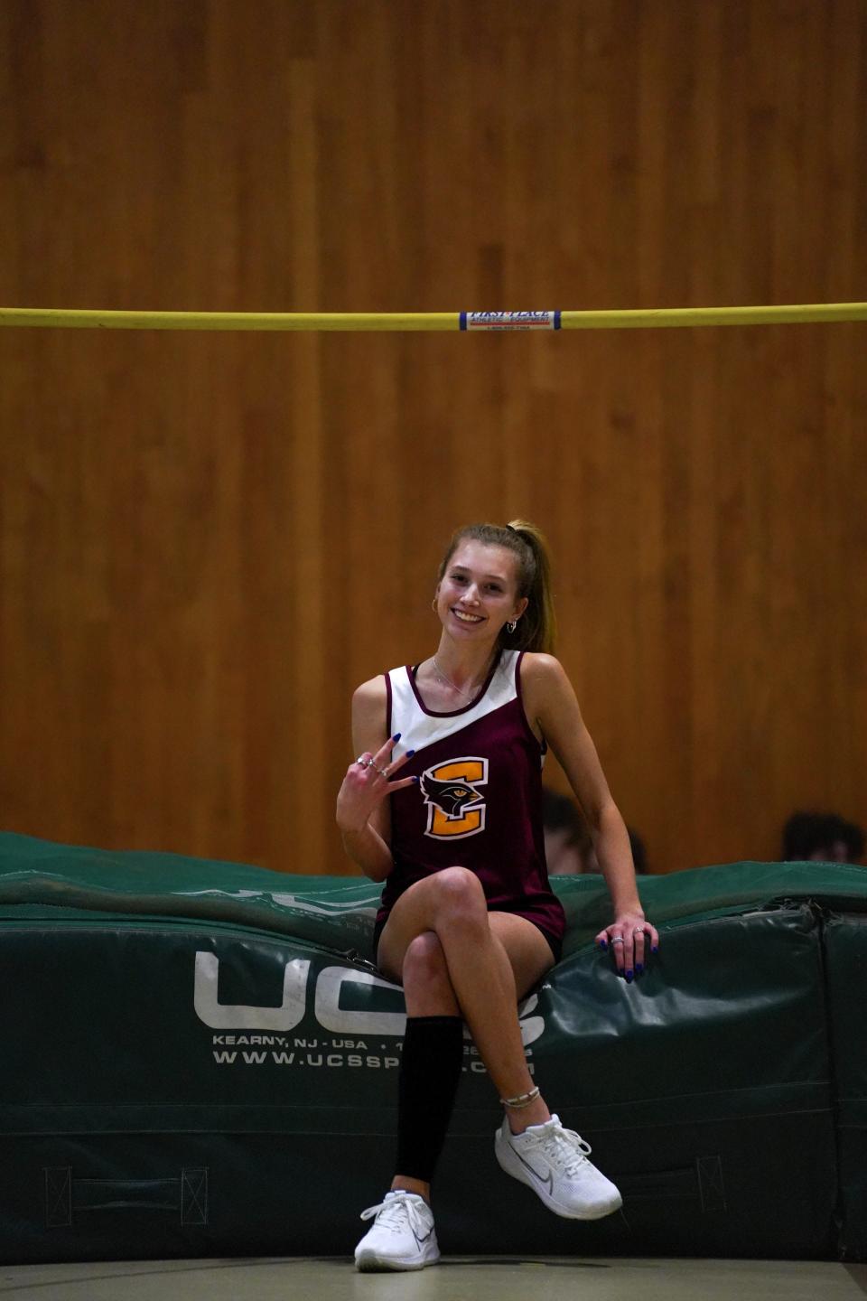 Case track and field athlete Hannah Santos hold up three fingers after breaking the school record for the third time.