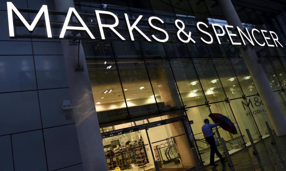 A man leaving a Marks & Spencer store in London