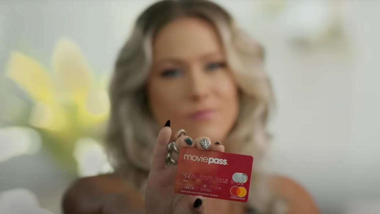  A still taken from the trailer of MoviePass, MovieCrash of a girl holding a card. 