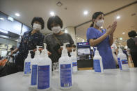 Christians wearing face masks to help protect against the spread of the new coronavirus use hand sanitizer before attending a service at the Yoido Full Gospel Church in Seoul, South Korea, Sunday, July 5, 2020. (AP Photo/Ahn Young-joon)