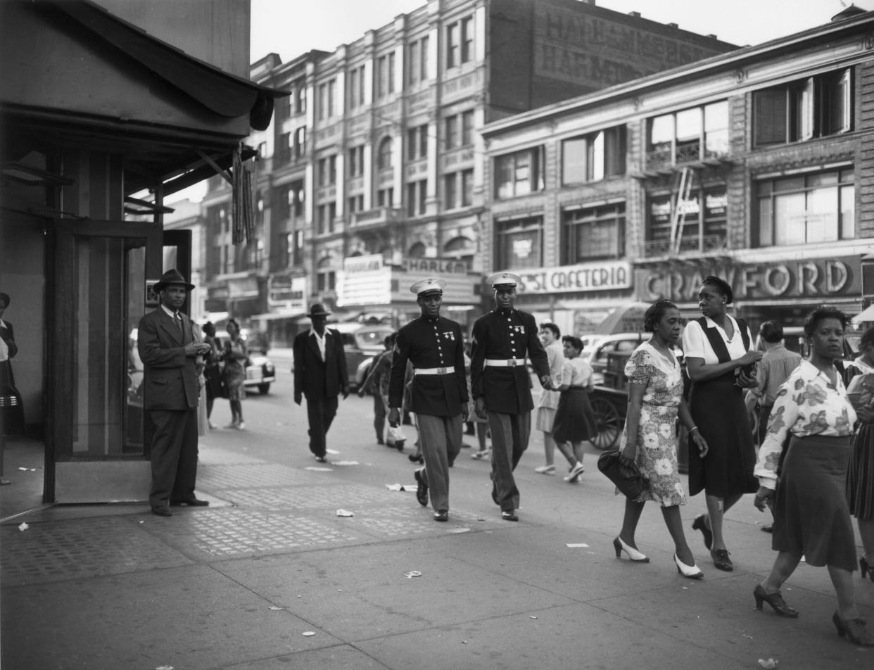 Two African-American Marines walk down a street in Harlem, New York City, in June 1943.