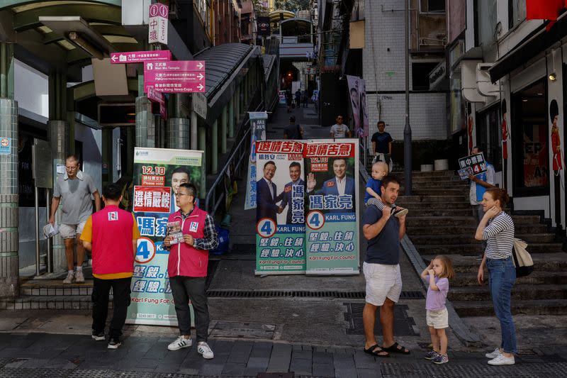 Volunteers campaign for their party during the District Council election in Hong Kong