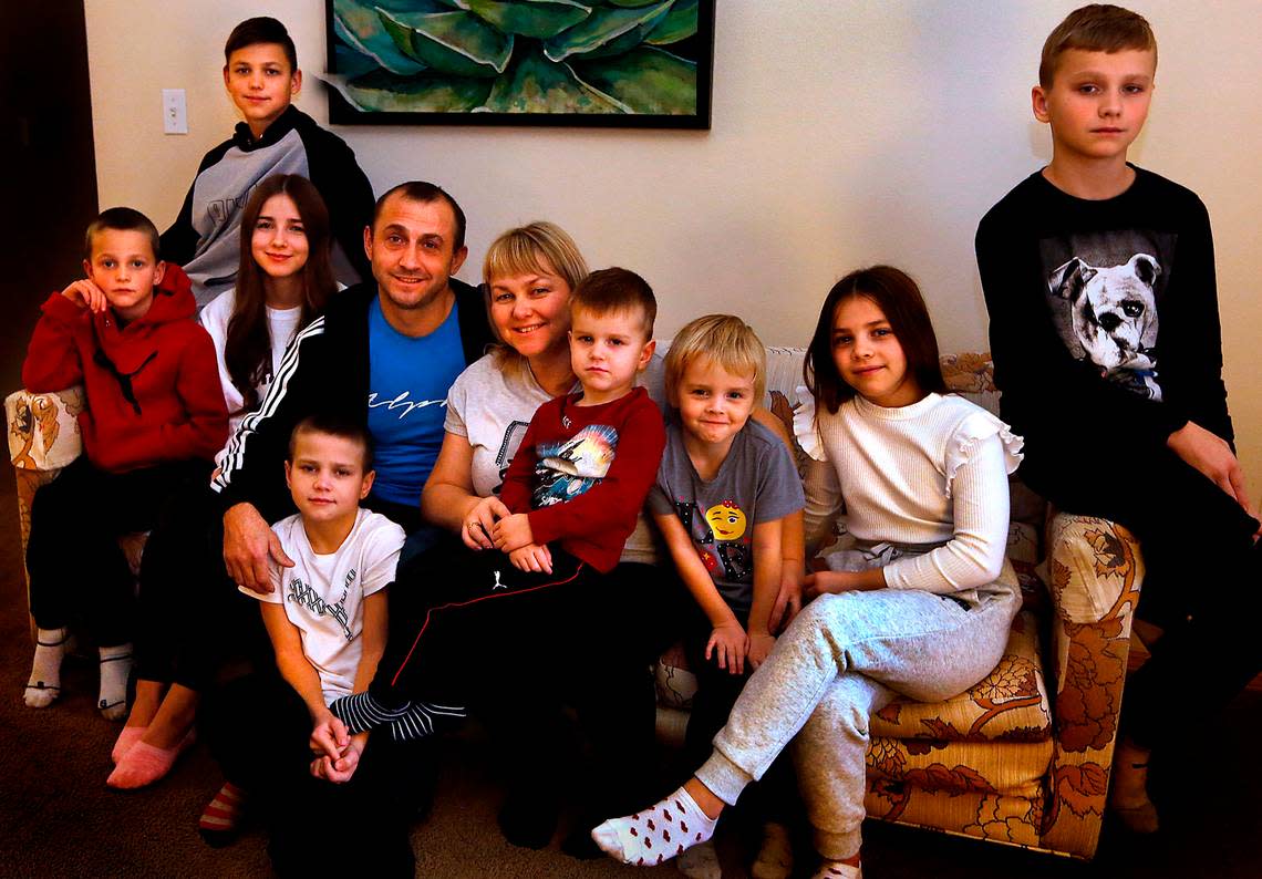 The Sydorchuk family fled from the Ukraine on Nov. 1 and are currently living in an apartment in west Pasco. From left, they are: Matvii, 8, Nikodym, 15, Zinaidia, 19, Yurii, 45, Nadiia, 41, Mark, 3, Evelina, 5, Daniela, 11, Tymofii, 13 and Yurii, 9, kneeling on the floor.