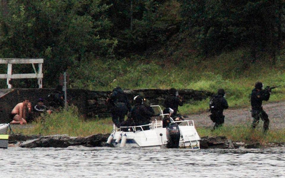 People watch as members of Norwegian Special Forces land by boat on the shore of the island of Utoeya July 22, 2011, after a shooting took place at a meeting of the youth wing of Norway's ruling Labour Party - Reuters