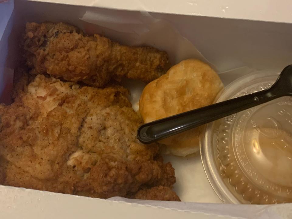 Fried chicken, biscuit, and gravy in a KFC box