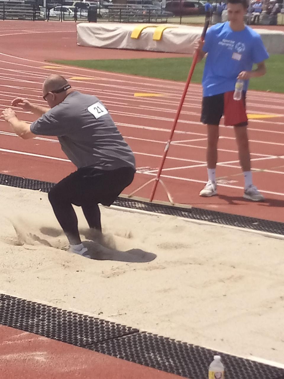Steve Hazelip sticks a landing in the running long jump