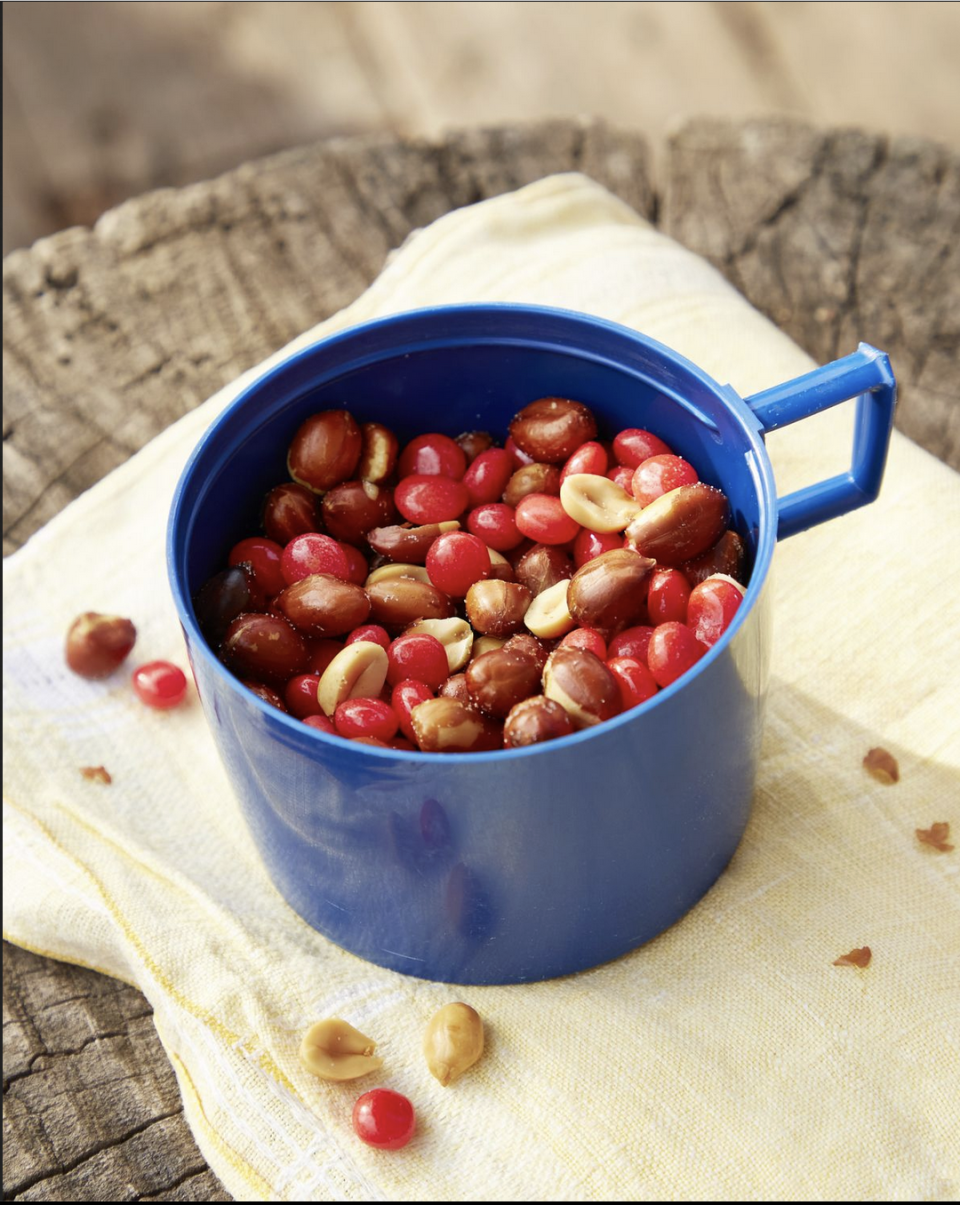 red hots and peanut snack mix in a thermos top