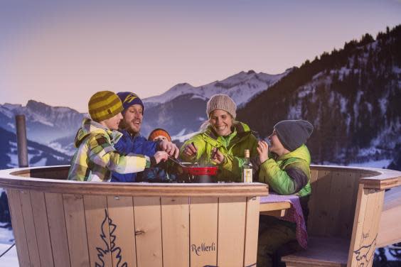 Eating molten cheese in the dairy's giant fondue pot (Gstaad tourist board)