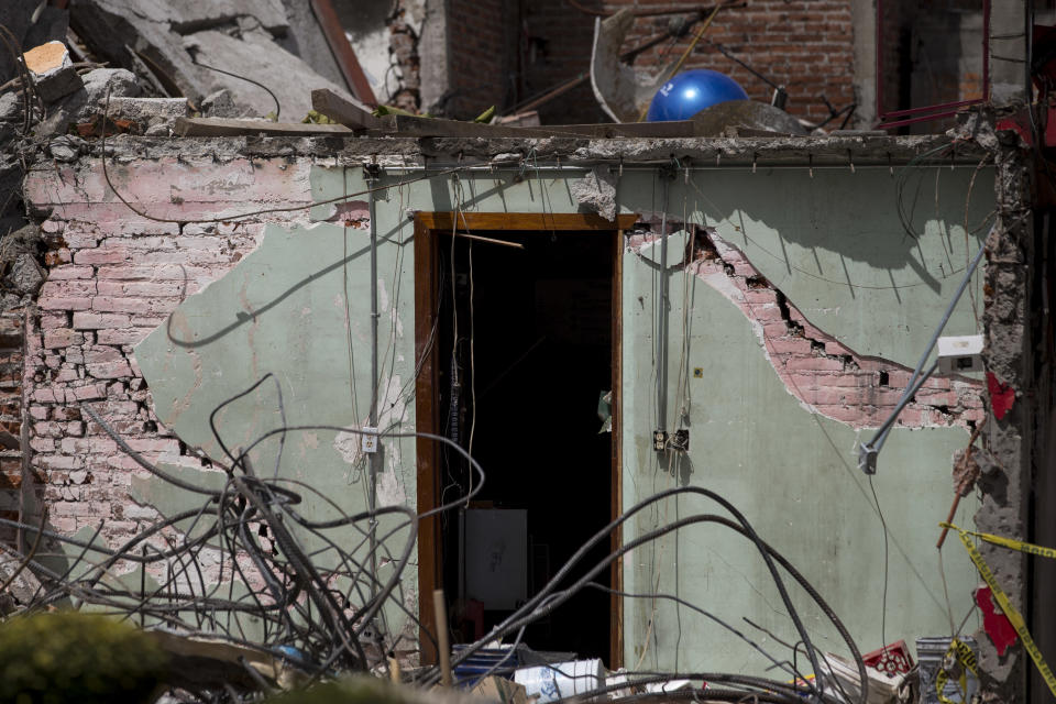 A door of a house, collapsed by a 7.1-magnitude earthquake, stands in San Gregorio Atlapulco, Mexico, Friday, Sept. 22, 2017. Mexican officials are promising to keep up the search for survivors as rescue operations stretch into a fourth day following Tuesday’s major earthquake that devastated Mexico City and nearby states. (AP Photo/Moises Castillo)