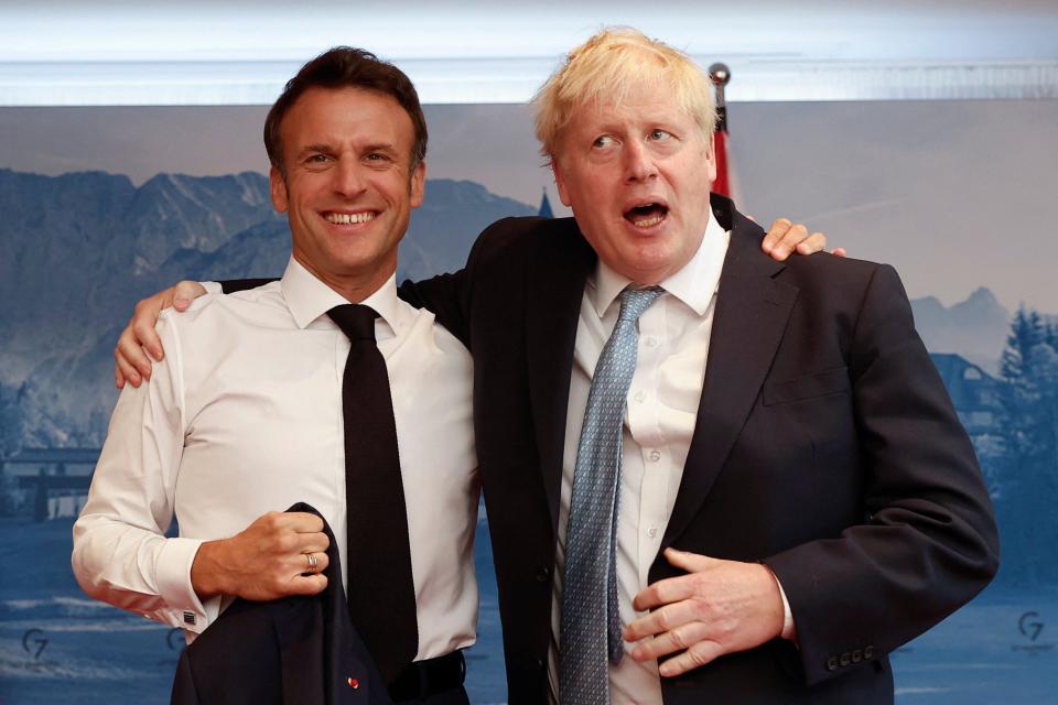 France's President Emmanuel Macron and British Prime Minister Boris Johnson pose for a picture during bilateral talks on 26 June 2022, in Elmau Castle, southern Germany, on the sidelines of a summit of the Group of Seven rich nations (AFP via Getty Images)