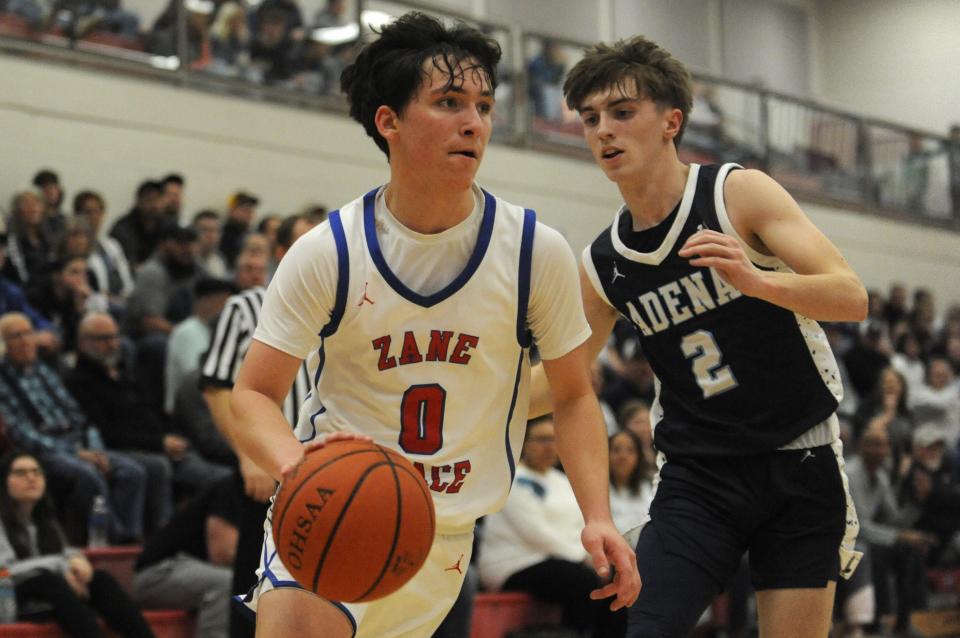 Zane Trace's Landen Jarrell (#0) drives past Adena's Easton Henness (#2) during the Pioneers' 53-43 win over the Warriors at Zane Trace High School on Feb. 2, 2024, in Kinnikinnick, Ohio.