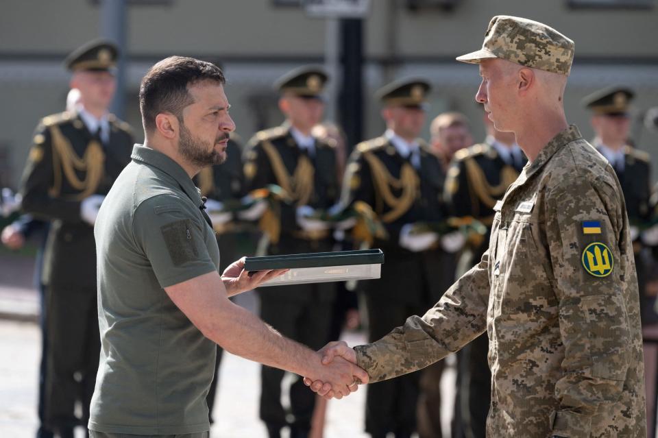 Ukraine's President Volodymyr Zelenskiy awards a Ukrainian service member during a ceremony marking the Day of Ukrainian Statehood (via REUTERS)