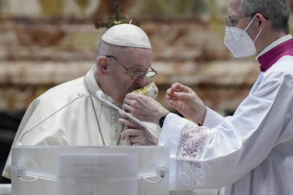Pope Francis kisses the stole within delivering his Urbi et Orbi Blessing after celebrating Easter Mass at St. Peter's Basilica at The Vatican Sunday, April 4, 2021, during the Covid-19 coronavirus pandemic. (Filippo Monteforte/Pool photo via AP)