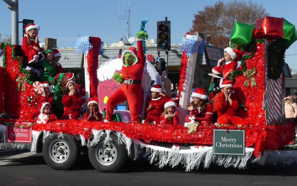 The 75th Annual Victorville Christmas Parade on Saturday included the Talent Planet float that featured over a dozen child performers who acted shocked as the Grinch danced mischiefly among the group.