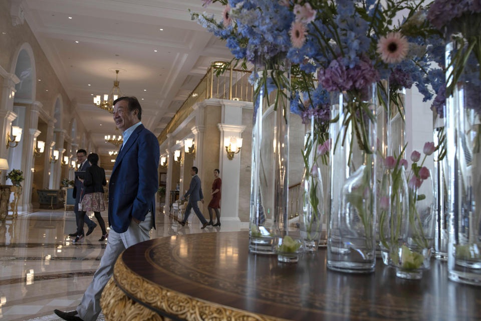 In this Aug. 20, 2019, photo, Huawei's founder Ren Zhengfei, walks past an opulent corridor in the company campus in Shenzhen in Southern China's Guangdong province. Ren says its troubles with President Donald Trump are hardly the biggest crisis he has faced while working his way from rural poverty to the helm of China’s first global tech brand. (AP Photo/Ng Han Guan)