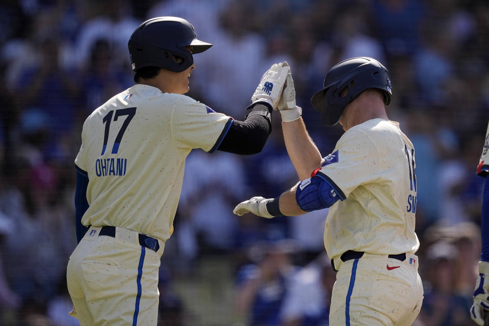 Los Angeles Dodgers' Will Smith, right, is congratulated by Shohei Ohtani after hitting a two-run home run during the first inning of a baseball game against the Milwaukee Brewers Saturday, July 6, 2024, in Los Angeles. (AP Photo/Mark J. Terrill)