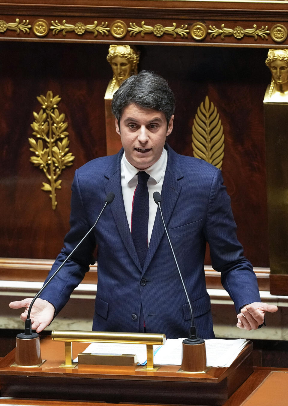 French Prime Minister Gabriel Attal gestures as he speaks to the lawmakers at the National Assembly, Tuesday, Jan. 30, 2024 in Paris. French Prime Minister Gabriel Attal said on Tuesday his top priority is to boost employment in his general policy address to lawmakers, three weeks after he was appointed. Attal is facing his first major challenge as angry farmers are protesting across the country and around Paris against low wages and other problems.(AP Photo/Michel Euler)