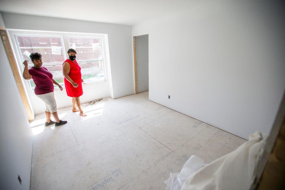 Tanya Harrison-Mantle, left, shows Debra Walker one of the bedrooms of the duplexes during an open house Friday at Hoose Court Townhomes in South Bend.