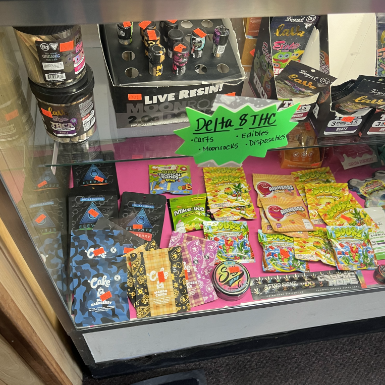 A display case full of cannabis-infused edibles, including items that look like Mike and Ike, Airhead, and Life Saver candies.