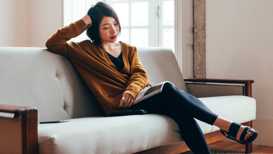 Signs Your Lifestyle Is To Sedentary: woman sitting casually on the couch