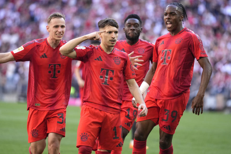 Bayern Munich players celebrate a goal that was later disallowed by a VAR decision during the German Bundesliga soccer match between Bayern Munich and VfL Wolfsburg at the Allianz Arena in Munich, Germany, Sunday, May 12, 2024. (AP Photo/Matthias Schrader)
