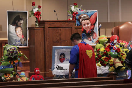 FILE PHOTO: Dale Hall, dressed in a Superman outfit, stands before the casket during the funeral for his brother 6-year-old Jacob Hall at Oakdale Baptist in Townville, South Carolina October 5, 2016. REUTERS/Ken Ruinard/Pool/File Photo