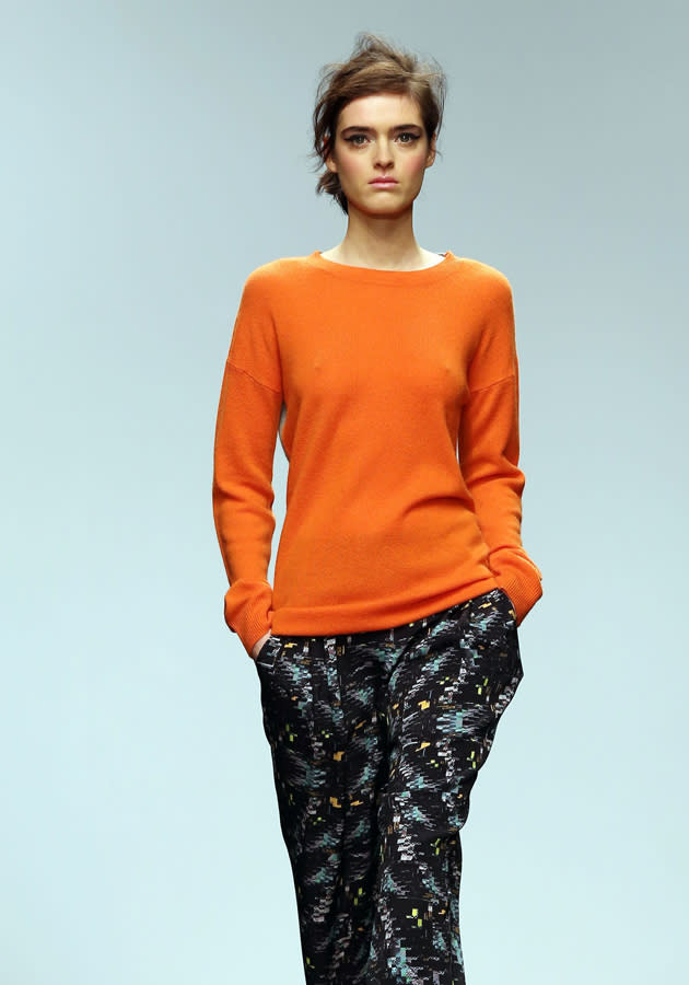 <b>London Fashion Week AW13: Zoe Jordan</b><br><br>Zoe Jordan teamed a colour-pop orange jumper with bold graphic-print trousers for this model's look.<br><br>©Rex