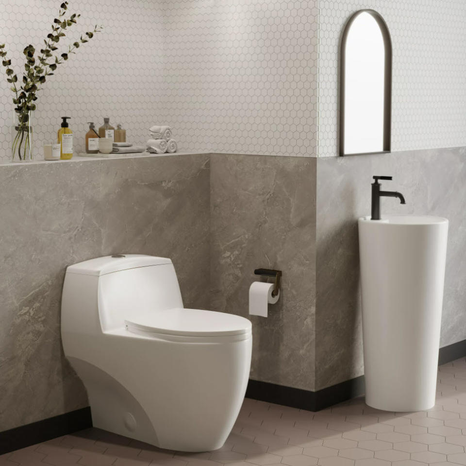 modern style white bathroom against a stone wall