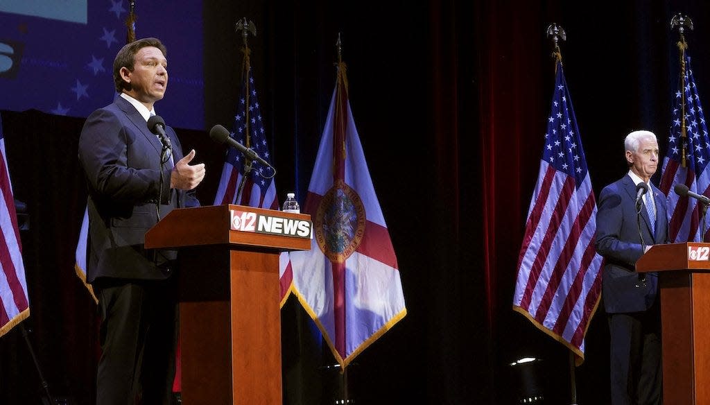 Florida's Republican Gov. Ron DeSantis and his Democratic challenger Charlie Crist participate in a debate at the Sunrise Theatre, Oct. 24, 2022, in Fort Pierce, Fla.