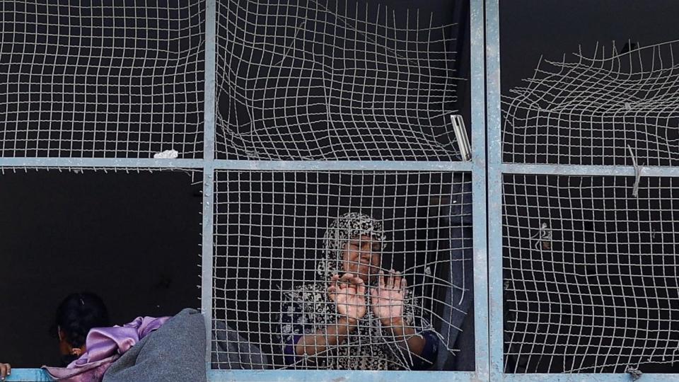 PHOTO: A Palestinian woman stands near the damaged windows of a classroom in a UNRWA school, after the air strike on a neighboring house to the school in Khan Younis, in the southern Gaza Strip, June 21, 2024. (Mohammed Salem/Reuters)