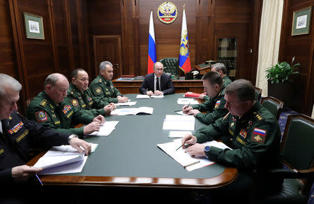 Russia's President Vladimir Putin (C) meets with the commanders of Russian military districts and the Northern Fleet as part of a session of the Defence Ministry Board in Moscow, Russia December 18, 2018. Sputnik/Mikhail Klimentyev/Kremlin via REUTERS