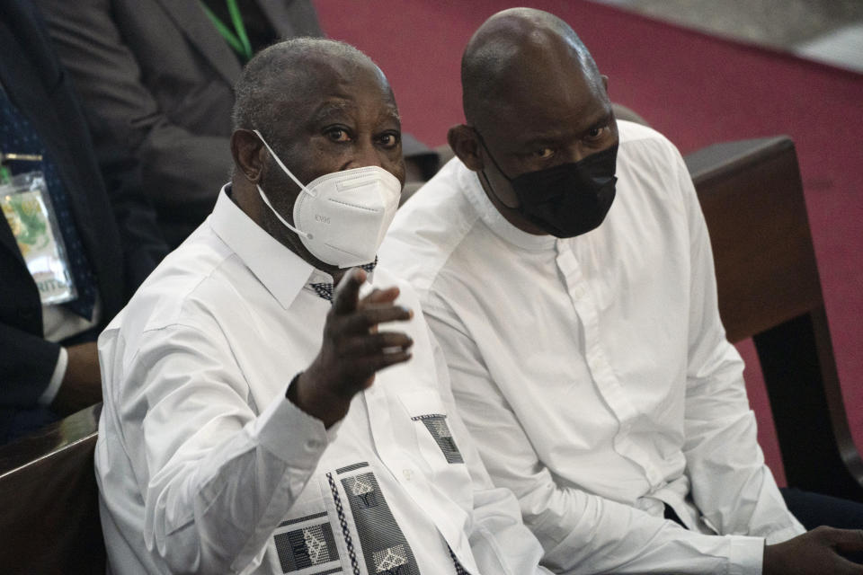 Former Ivorian president Laurent Gbagbo, left, points out as he attends a Mass at the Saint Paul's cathedral in Abidjan, Ivory Coast, Sunday, June 20, 2021. Gbagbo, who has returned to the country after nearly a decade, was extradited to the International Criminal Court at The Hague in 2011 and spent eight years awaiting trial on war crimes charges. A judge acquitted him in 2019, saying prosecutors had failed to prove their case. (AP Photo/Leo Correa)