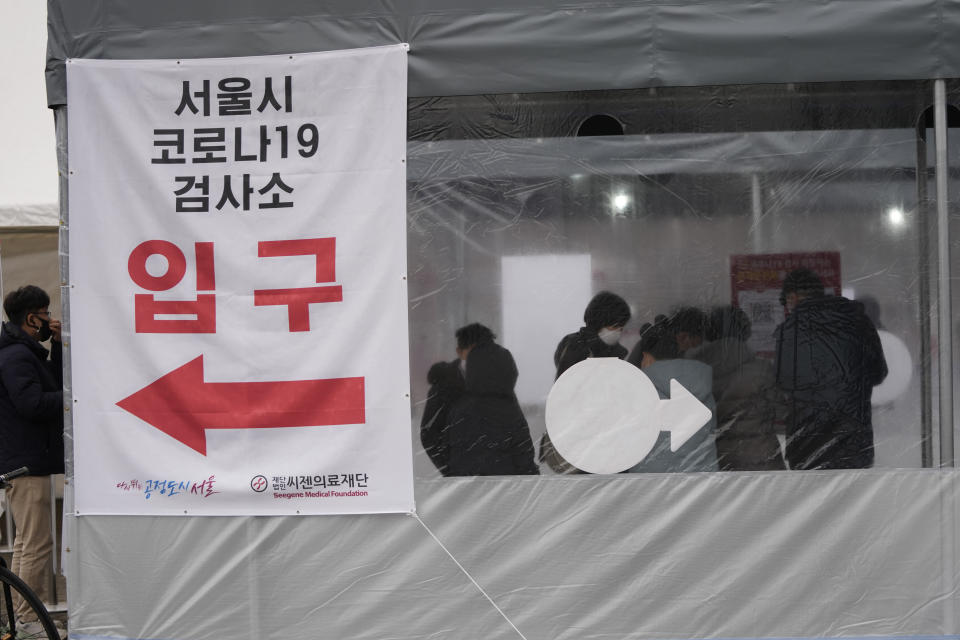 People queue in line for the coronavirus test at a temporary screening clinic for the coronavirus in Seoul, South Korea, Tuesday, Jan. 25, 2022. South Korea recorded more than 8,000 new coronavirus infections for the first time Tuesday as health authorities reshape the country's pandemic response to address a surge driven by the highly contagious omicron variant. (AP Photo/Lee Jin-man)